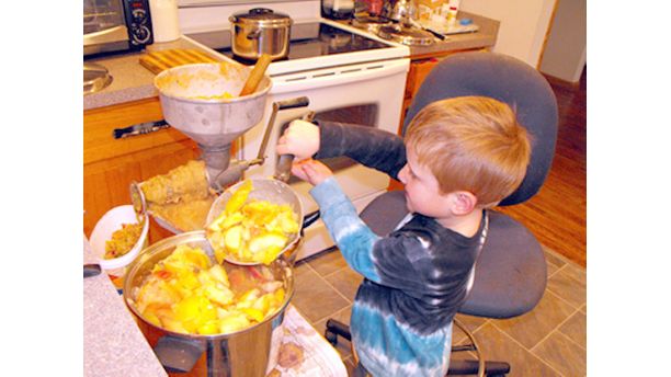 Nathan helps make applesauce